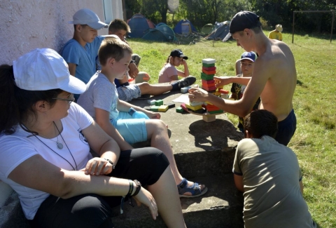 Mozg�sos �lm�nyprogramok a tizedik Hun T�borba - Mintegy hatvan t�boroz� vesz r�szt Erd�ly eg�sz ter�let�ről a Csillag�sv�ny Egyes�let �s az Ikafalvi Reform�tus Egyh�z �ltal szervezett tizedik Hun t�borba. A t�bor ideje alatt k�l�nb�ző vet�lkedők�n m�rhett�k �ssze a hunok a tud�sukat, r�termetts�g�ket. A rendezv�nyen k�sz�lt fot�k megtekinthetők a Z�ld Nap Egyes�let Facebook oldal�n.

Vas�rnap d�lut�n egy �gyess�gi vet�lkedő kidolgoz�s�ra h�vt�k meg a Z�ld Nap Egyes�let tagjait a szervezők. A nap első fel�ben a jelenl�vők az Environment+ projekt h�rom ESC �nk�ntes�vel Mariammal, �got�val �s Asiyevel ismerkedhettek meg. Ezt k�vetően az elm�lt �vekben kidolgozott Z�ld Nap-suli tantervv�zlat tev�kenys�geiből kaphattak egy �zel�tőt. Majd a helysz�nen egy j�tsz� z�n�t alak�tottak ki a k�zdiv�s�rhelyi z�ldnaposok, a Hun t�bor r�sztvevőit 8 fős csapatokba osztott�k �s m�ris kezdődhetett a verseny. A t�bb �r�s vet�lkedő el�rte a c�lj�t, hisz a mozg�s, a kreativit�s, a logikus gondolkod�s, valamint az el nem hanyagolhat� egy�ttműk�d�s, csoportmunka, versenyszellem fejleszt�se hossz� t�von meghat�rozhatja a r�sztvevők tanulm�nyi sikereit is. Az �nfeledten j�tsz� fiatalok figyelve �szrevehető volt, hogy a j�t�k sor�n a saj�t maguk el� �ll�tott akad�lyokat is �r�mmel �s �nk�nt k�zdik le. A tev�kenys�g z�r�sak�nt a Z�ld Nap Egyes�let gondoz�s�ban, a Bethlen G�bor Alapkezelő Zrt �ltal t�mogatott Bringabar�t k�zleked�s f�zetecsk�t is elvihett�k azok, akik helyesen t�lt�tt�k ki a vill�mgyors ker�kp�ros KRESZ tesztet.

K�sz�nj�k Bard�cz Csaba lelkip�sztornak a megh�v�st �s a kedves fogadtat�st.

Szerző: R�duly Attila

Fot�: Asiye Demirci